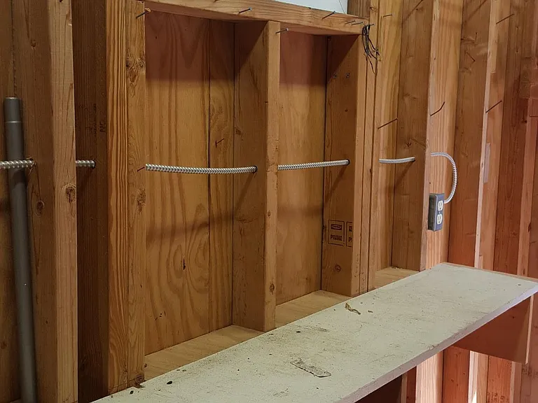 Inside the work shed. Very comfortable summer or winter. A heater would cozy it up. Plenty of E outlets and nails to hang stuff on.