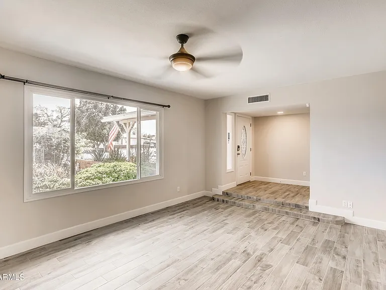 Large south-facing living room with high ceilings.