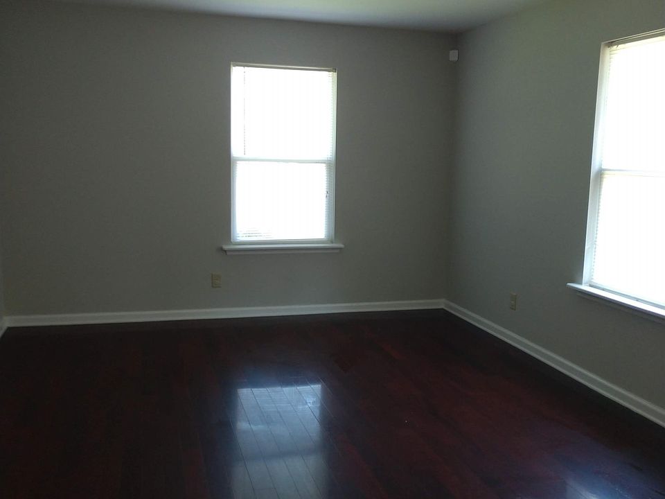 Large bedroom with wood flooring and large closets