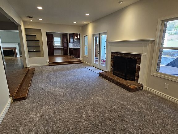 One-step down expansive family room with oversized fireplace, french doors to backyard patio. New carpet for comfortable relaxation.