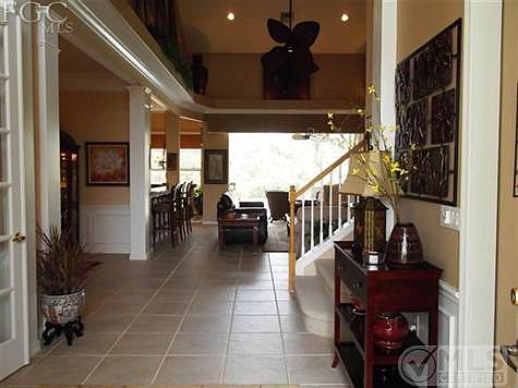 The entry from Foyer gives you wide open views thru the living room to lanai, pool and golf course
