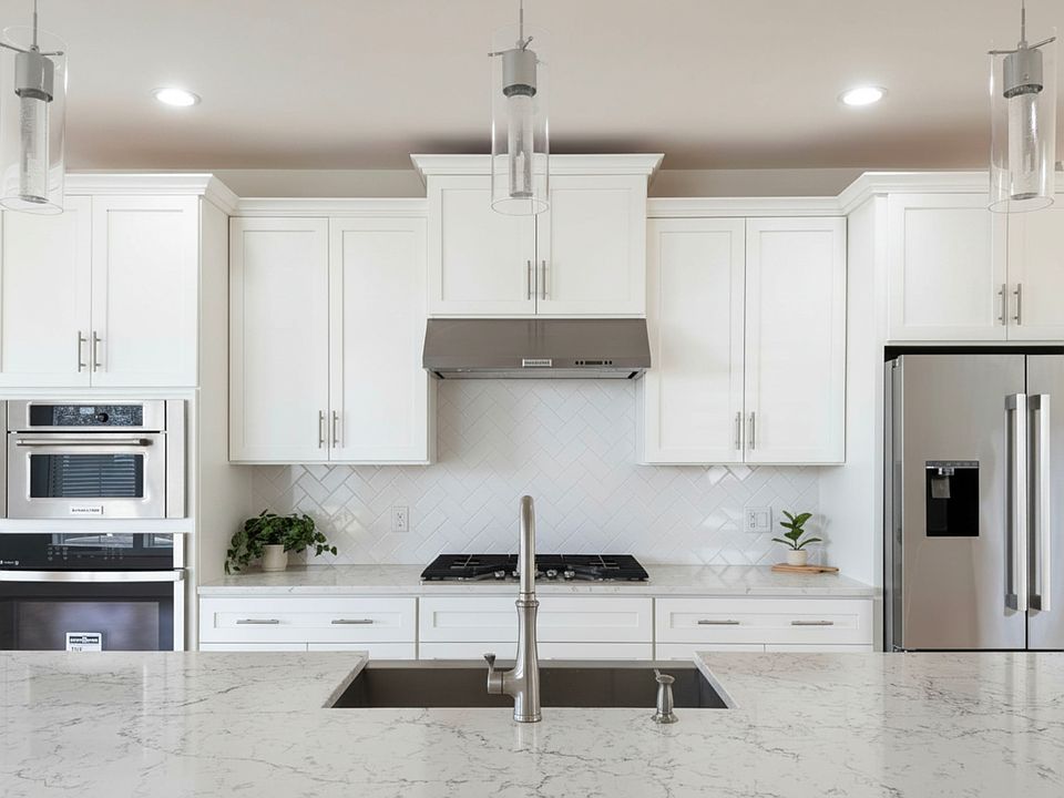 Pristine and modern kitchen with sleek finishes and oversized quartz island.