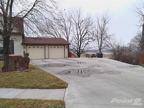 Side view showing 2 car garage.