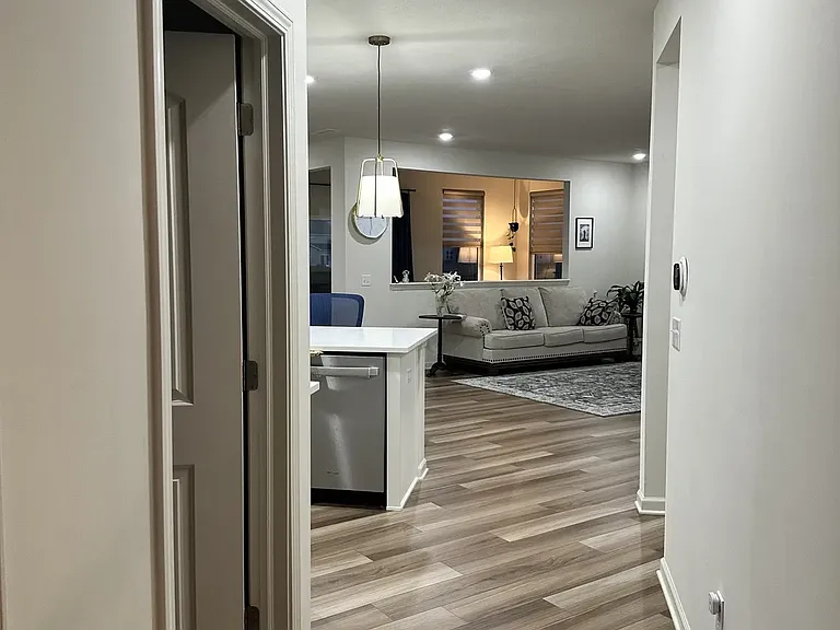 Entry to the living area, with a walk-in, spacious kitchen pantry conveniently located to the left