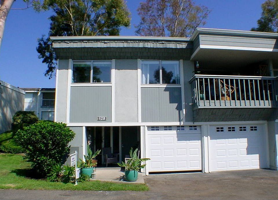 Front of home with balcony, 2 car attached garage, end unit in hills.