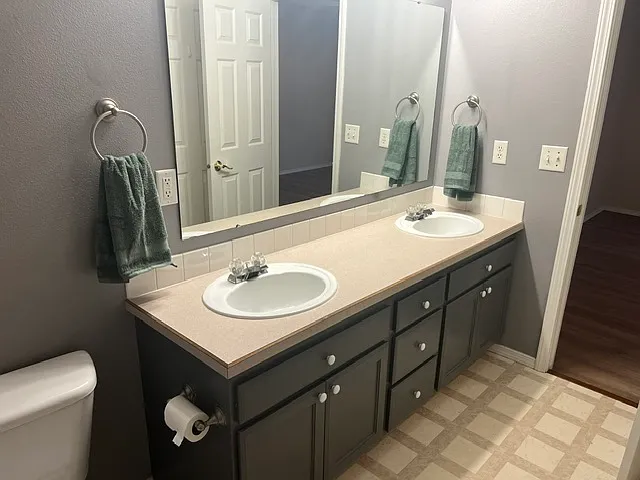 Roomy master bath double vanity and lots of storage plus a grand linen closet behind the entry door!