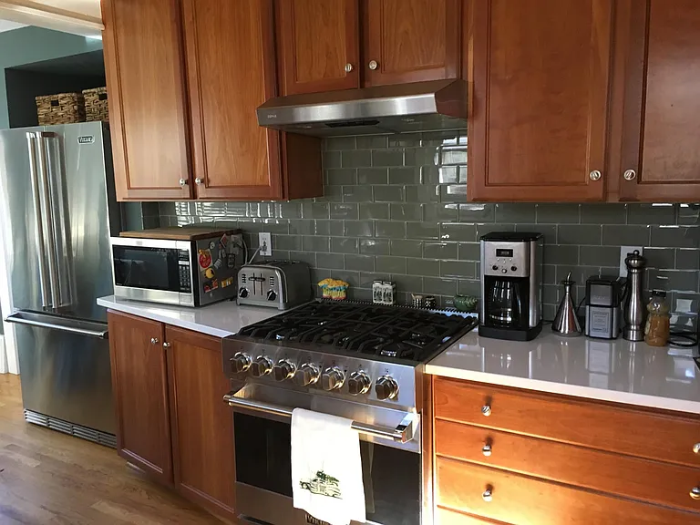 Kitchen with Cherry wood cabinets, Viking stove and refrigerator