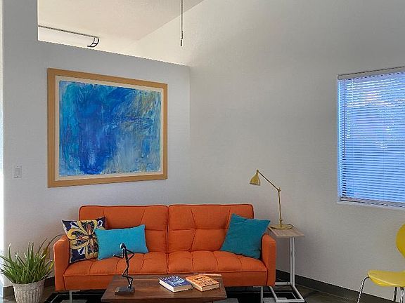 High ceilings, large windows, modern ceiling fans, and open floorplan give an expansive and interesting feel to the home.