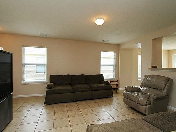 Living area with windows allowing light into the living spaces of this move in ready home. Breakfast bar