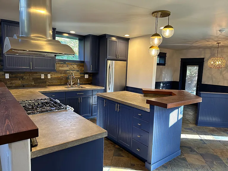 View of kitchen from pantry door (just inside garage entry door). Dining room visible in the back