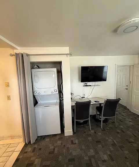 Stacked washer/dryer, desk, TV