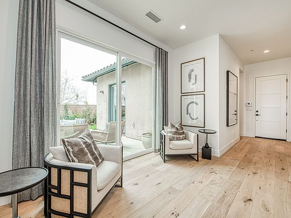 Front entry opens to a bright and airy space with plenty of light from the side courtyard doors.