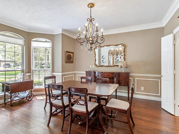 The large dining room has a beautiful bay window that lets in lots of light and provides additional space to extend the dining table for larger dinner parties and holiday meals.
