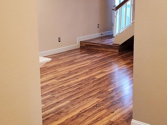 From dining area, past past fireplace and across the living room to the front entry.