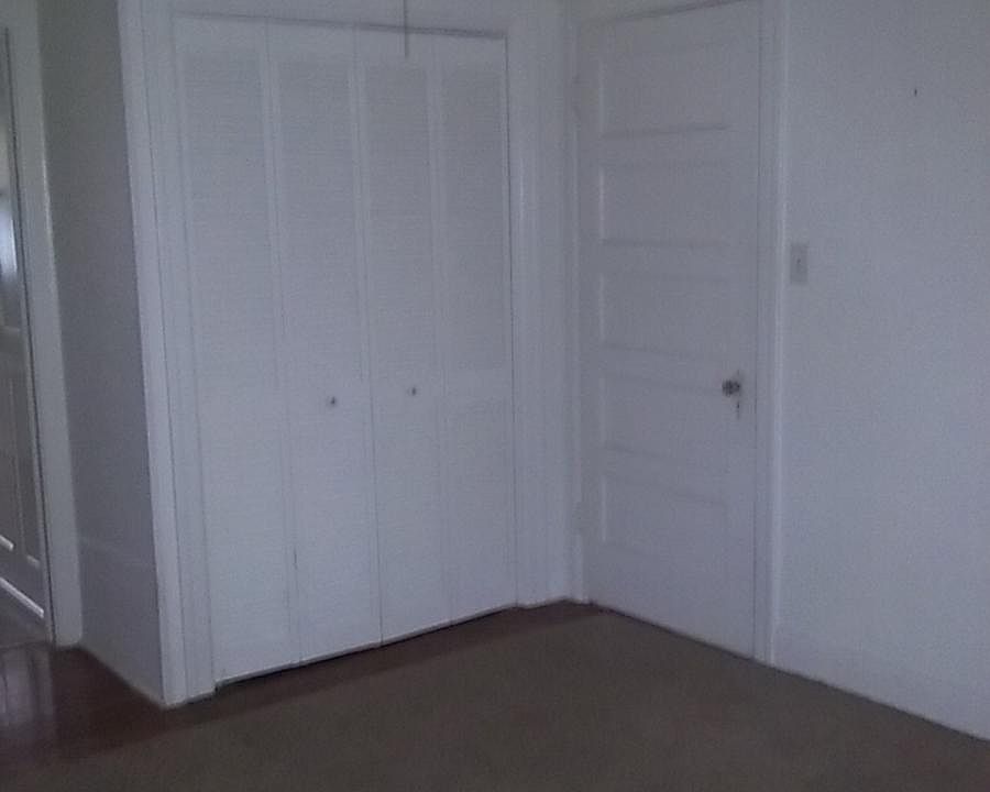 Bedroom, The carpet has been removed. The floor is hardwood.