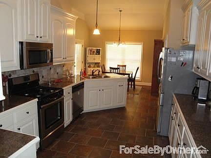Kitchen attached to dinning room : stainless steel microwave, stove, and dishwasher included, cabine