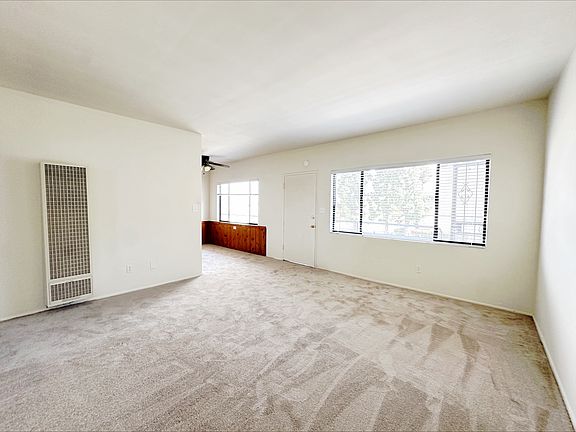 Spacious living room with plush new carpeting!