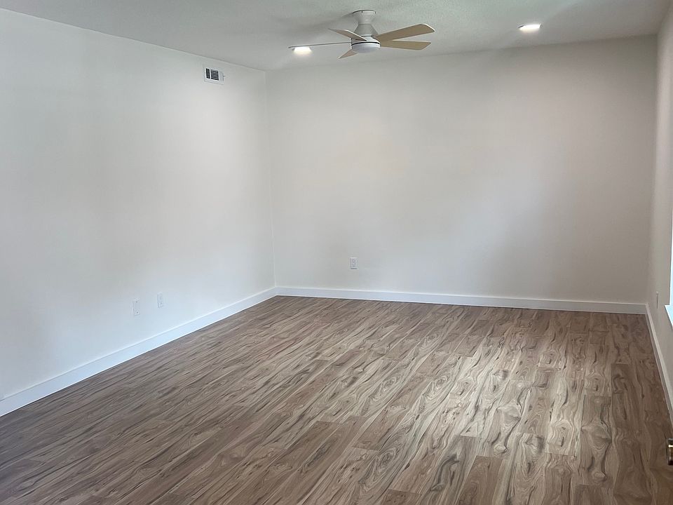Living room with fan and recessed lights. Unfurnished.