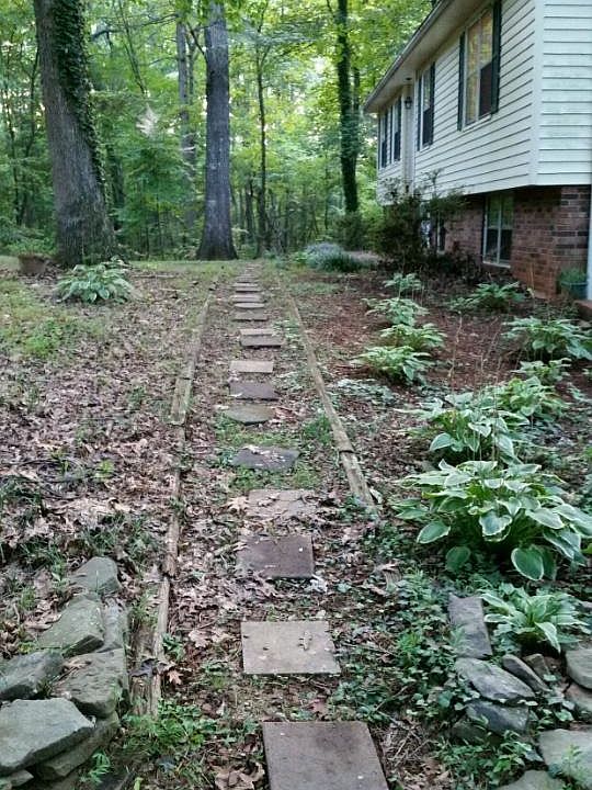 Side view of the house. Wooded lot.