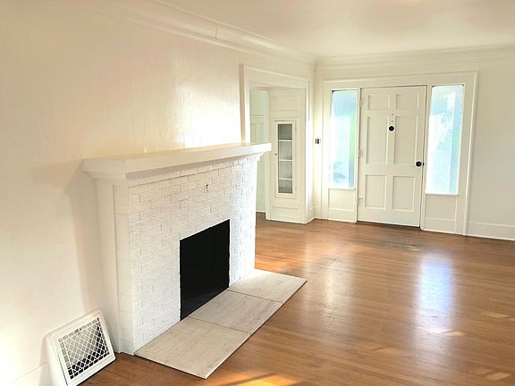 Entry into living room with cove ceiling mouldings.
