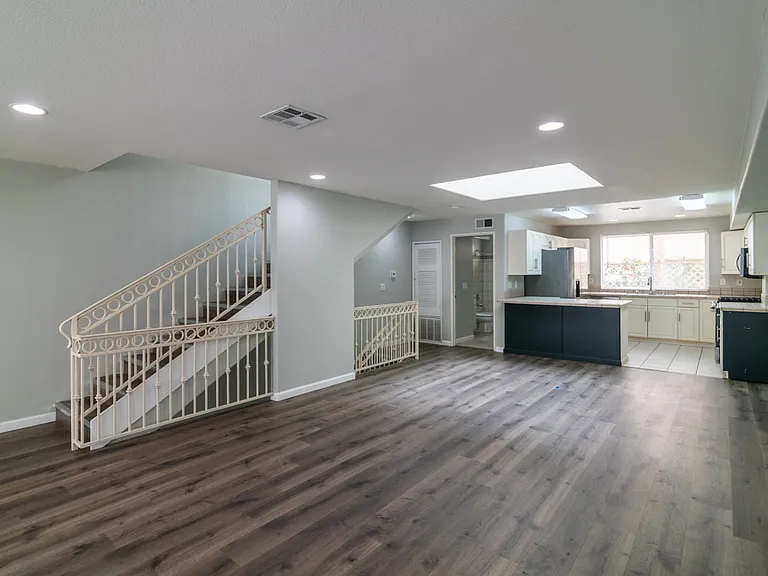 View of living area, kitchen and full bathroom on 2nd level