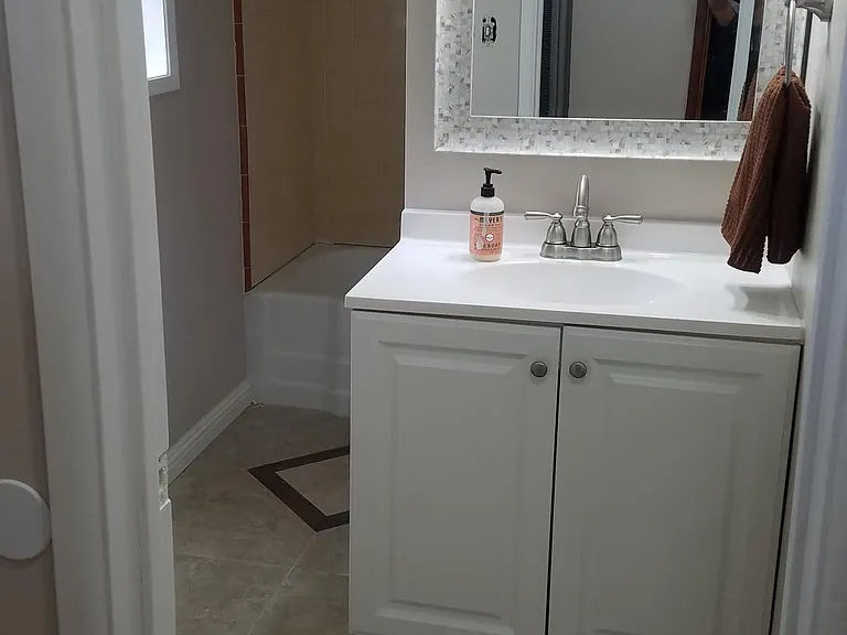 custom tile design with modern vanity, lighting and fixtures