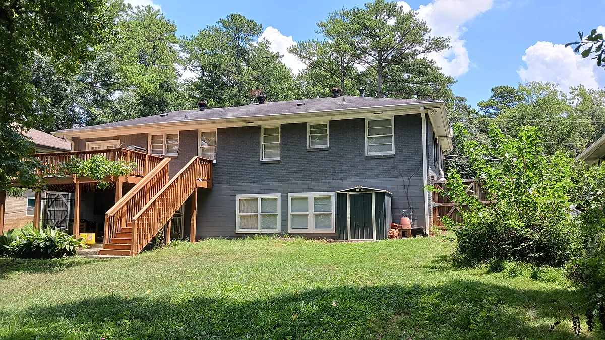 Back of house: The first floor sits above a full basement. French doors open onto a spacious deck overlooking the back yard. - 1657 Capistrana Pl