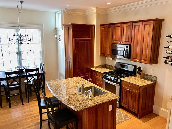 Renovated kitchen with cherry cabinets, stainless steel appliances, and granite countertops