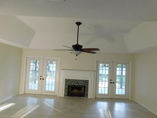 View from the entryway into the living room with wood burning fireplace