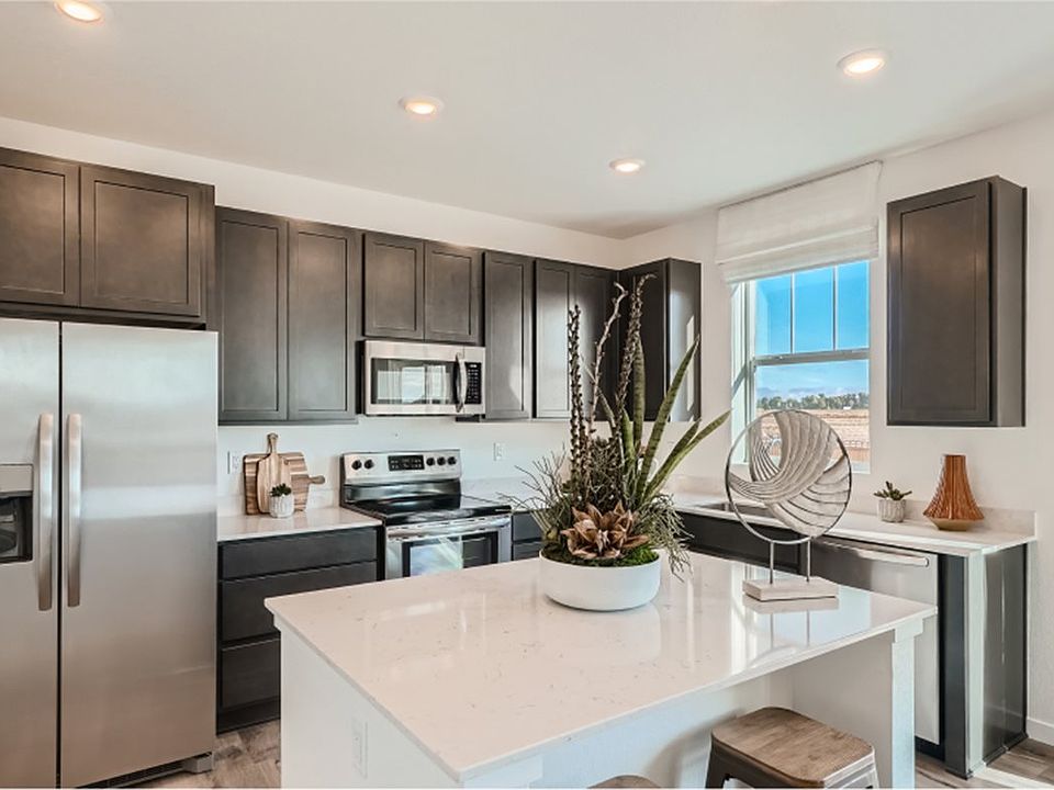 The kitchen features brand-new stainless steel appliances, designer cabinets, quartz countertops and a pantry for added food and appliance storage.