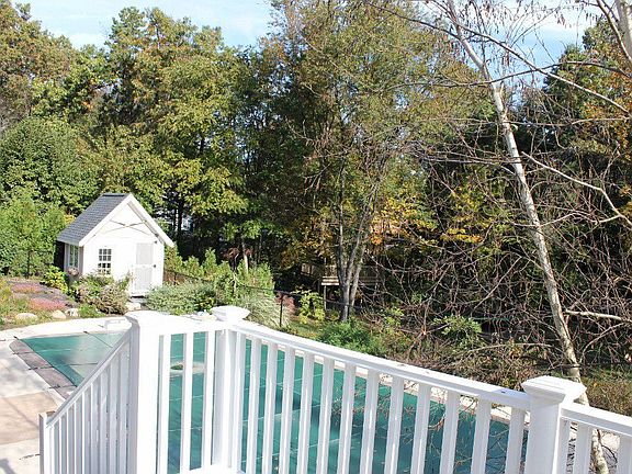 Deck overlooking inground pool and pool house. and tree house! 