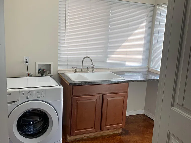 laundry room with washer dryer and wash sink