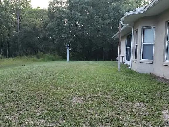 Backyard view surrounded by nature. Nearest neighbors are 2 lots away on either side