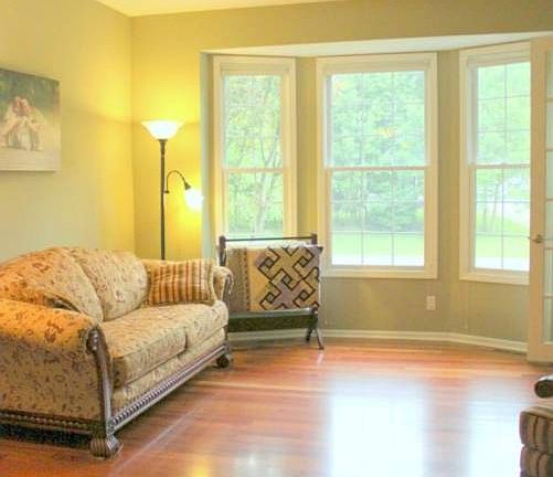 Warm Brazilian Cherry floors run from the foyer, through the formal living room...