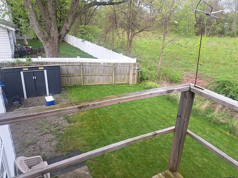 View of back yard from deck. Shed is included in rental.