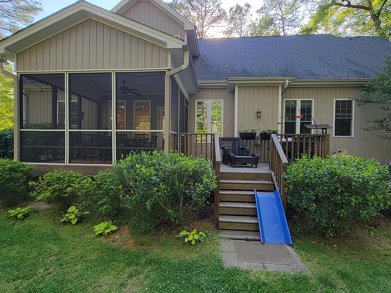 The back of the house has a screened in porch and an open deck to help you enjoy the private backyard, surrounding Forest, and wild birds.