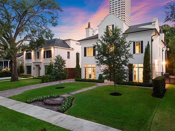 [Front and Side Elevation]The driveway on the west side and yard on the east side are both gated.