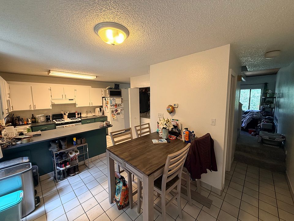 Kitchen and dining area. Hallway to half batch, stairs, and living room.