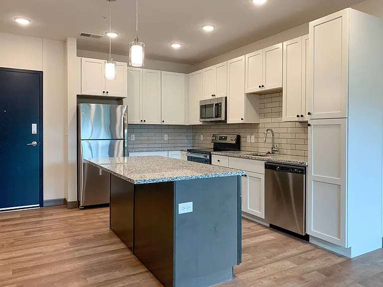 Beautiful white cabinets, large island with seating in the 1 bed Marble #207