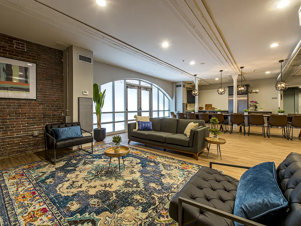 Spacious resident lounge with gathering areas and community social spaces