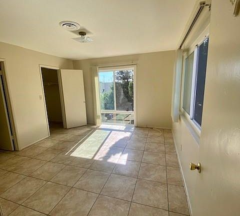 Bedroom 1 with large windows, walk-in-closet and direct access to bathroom.