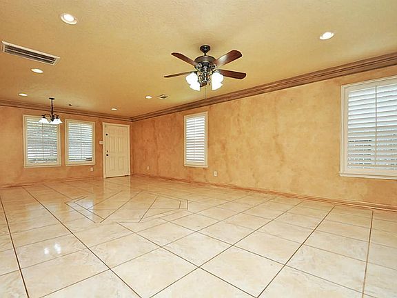 Huge living space with lots of windows and natural lighting.