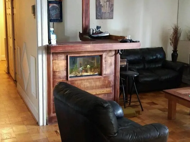 sitting room with leather sofas and a custom built bar