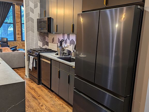 This photo reflects the new Samsung Bespoke smart appliances in navy steel.