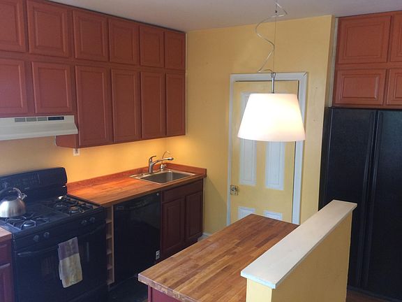 Efficient Galley Kitchen with butcher block counter tops and access to half bath.