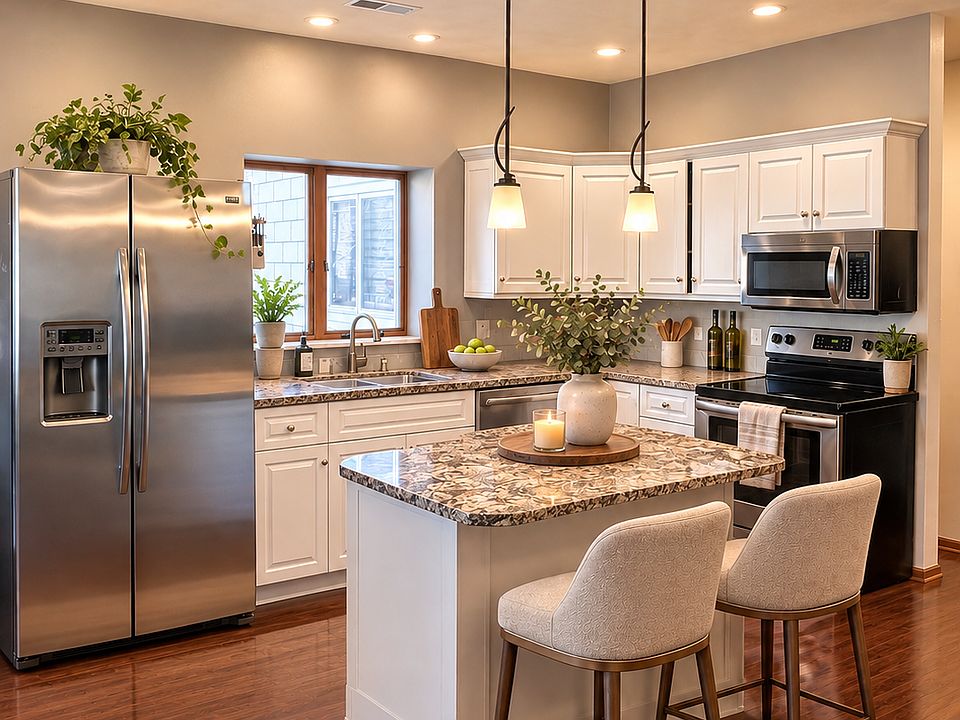 Open concept kitchen with granite countertops, stainless steel appliances, and island.