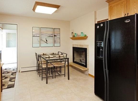 Two sided fireplace with eat-in kitchen dining space