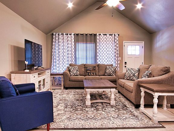 Comfortable open-concept living room flowing seamlessly into the dining area and kitchen.