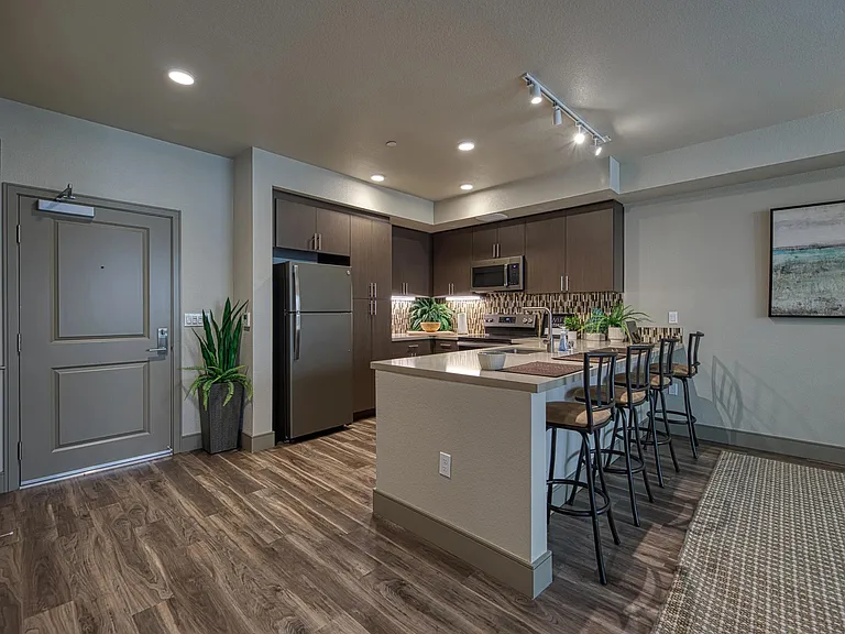 Warm kitchen entry with a chef island, open layout, and seating that supports easy conversation and meals.
