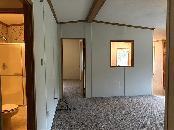 Living room access to bathroom, #3 bedroom, and kitchen/dining room.